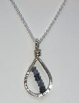 petite hand hammered sterling silver teardrop pendant with diagonal strand of iolite faceted rondelles